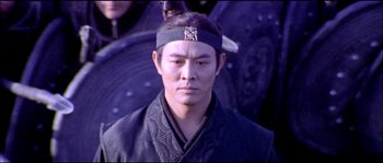 Movie still from “Hero” (2002), directed by Yimou Zhang – A man in a black robe and a black headband; Medium shot, High angle