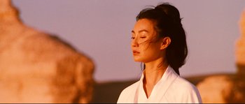 Movie still from “Hero” (2002), directed by Yimou Zhang – A woman in a white shirt is meditating; Close Up shot, Low angle