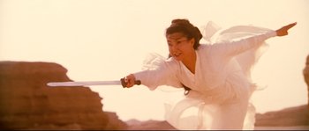 Movie still from “Hero” (2002), directed by Yimou Zhang – A woman in a white robe holding a sword; Medium shot, Low angle