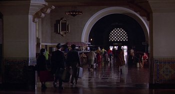 Movie still from “Hickey & Boggs” (1972), directed by Robert Culp – A group of people walking through a building; Extreme Wide shot, High angle