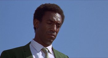 Movie still from “Hickey & Boggs” (1972), directed by Robert Culp – A person wearing a suit and tie; Close Up shot, Low angle