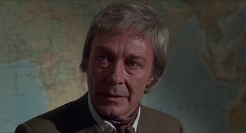 Movie still from “Hickey & Boggs” (1972), directed by Robert Culp – An older man wearing a brown suit and a red neck tie; Close Up shot, Low angle