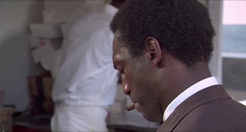 Movie still from “Hickey & Boggs” (1972), directed by Robert Culp – A person smoking a cigarette; Close Up shot, Over the shoulder angle
