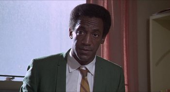 Movie still from “Hickey & Boggs” (1972), directed by Robert Culp – A person wearing a suit and tie; Close Up shot, Low angle