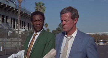 Movie still from “Hickey & Boggs” (1972), directed by Robert Culp – A couple of men standing next to each other; Medium shot, Low angle