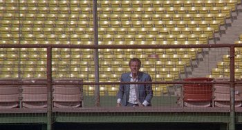 Movie still from “Hickey & Boggs” (1972), directed by Robert Culp – A man standing in front of a wall with lights on it; Extreme Wide shot, High angle