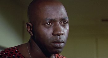 Movie still from “Hickey & Boggs” (1972), directed by Robert Culp – A person wearing a necklace; Close Up shot, Low angle