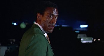 Movie still from “Hickey & Boggs” (1972), directed by Robert Culp – A person wearing a suit and tie; Close Up shot, Low angle