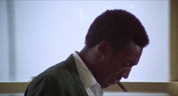 Movie still from “Hickey & Boggs” (1972), directed by Robert Culp – A person holding a cigarette in his mouth; Close Up shot, Low angle