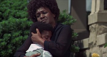 Movie still from “Hickey & Boggs” (1972), directed by Robert Culp – An older woman holding a young boy in her arms; Close Up shot, Low angle