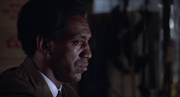 Movie still from “Hickey & Boggs” (1972), directed by Robert Culp – A person wearing a suit and tie; Close Up shot, Low angle