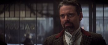 Movie still from “Hidalgo” (2004), directed by Joe Johnston – A person wearing a suit and tie; Close Up shot, Over the shoulder angle