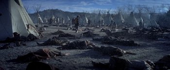 Movie still from “Hidalgo” (2004), directed by Joe Johnston – A group of people standing in the dirt near tents; Extreme Wide shot, High angle
