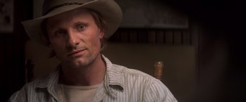 Movie still from “Hidalgo” (2004), directed by Joe Johnston – A person wearing a cowboy hat; Close Up shot, Over the shoulder angle