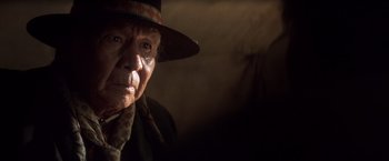 Movie still from “Hidalgo” (2004), directed by Joe Johnston – An old man wearing a hat looking at the camera; Close Up shot, Over the shoulder angle
