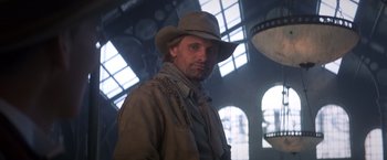 Movie still from “Hidalgo” (2004), directed by Joe Johnston – A man wearing a hat standing in front of a window; Close Up shot, Low angle