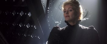Movie still from “Hidalgo” (2004), directed by Joe Johnston – A woman in a black dress standing in a dark room; Close Up shot, Low angle