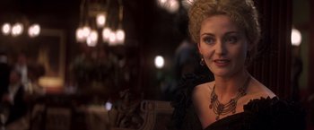 Movie still from “Hidalgo” (2004), directed by Joe Johnston – A woman in a black dress and a red necklace; Close Up shot, Over the shoulder angle