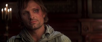 Movie still from “Hidalgo” (2004), directed by Joe Johnston – A person with a bruise on his face; Close Up shot, Over the shoulder angle