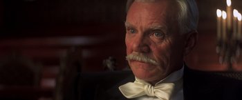 Movie still from “Hidalgo” (2004), directed by Joe Johnston – An old man with a mustache and a white bow tie; Close Up shot, Low angle