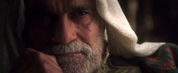 Movie still from “Hidalgo” (2004), directed by Joe Johnston – An old man with a beard and a white head covering; Close Up shot, Low angle