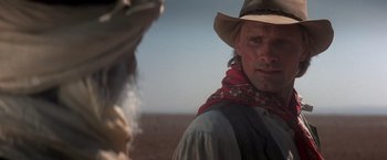 Movie still from “Hidalgo” (2004), directed by Joe Johnston – A man wearing a cowboy hat and a scarf; Close Up shot, Over the shoulder angle