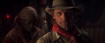 Movie still from “Hidalgo” (2004), directed by Joe Johnston – A man wearing a cowboy hat and a red scarf; Close Up shot, Over the shoulder angle