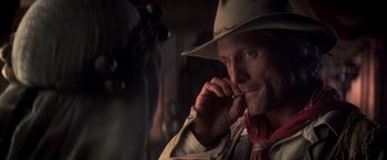 Movie still from “Hidalgo” (2004), directed by Joe Johnston – A man in a cowboy hat is talking on a cell phone; Close Up shot, Over the shoulder angle