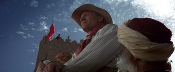 Movie still from “Hidalgo” (2004), directed by Joe Johnston – A man wearing a cowboy hat and holding a gun; Close Up shot, Low angle