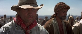 Movie still from “Hidalgo” (2004), directed by Joe Johnston – A man wearing a cowboy hat and a scarf; Close Up shot, Over the shoulder angle