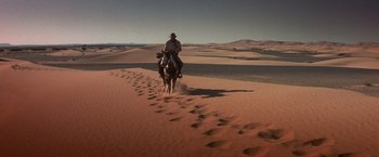 Movie still from “Hidalgo” (2004), directed by Joe Johnston – A man is riding a horse through the desert; Extreme Wide shot, High angle