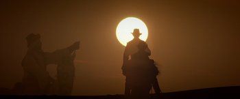 Movie still from “Hidalgo” (2004), directed by Joe Johnston – A person riding a horse in front of the setting sun; Wide shot, Low angle