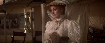 Movie still from “Hidalgo” (2004), directed by Joe Johnston – A woman wearing a white dress and a straw hat; Medium shot, Low angle