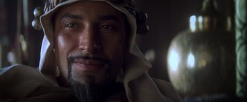 Movie still from “Hidalgo” (2004), directed by Joe Johnston – A person with a beard wearing a headdress; Close Up shot, Over the shoulder angle