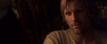 Movie still from “Hidalgo” (2004), directed by Joe Johnston – A man's face in a dark room; Close Up shot, Over the shoulder angle