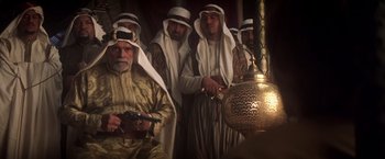 Movie still from “Hidalgo” (2004), directed by Joe Johnston – A group of men standing next to each other in a room; Medium shot, Over the shoulder angle