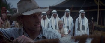 Movie still from “Hidalgo” (2004), directed by Joe Johnston – A group of men in white robes and hats; Close Up shot, Over the shoulder angle