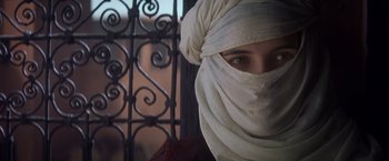 Movie still from “Hidalgo” (2004), directed by Joe Johnston – A woman wearing a head covering and a white scarf; Close Up shot, Over the shoulder angle