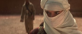 Movie still from “Hidalgo” (2004), directed by Joe Johnston – A woman with a white head covering and a man in a brown robe; Close Up shot, Over the shoulder angle