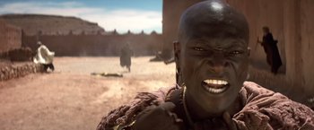 Movie still from “Hidalgo” (2004), directed by Joe Johnston – A man with a beard is smiling for the camera; Close Up shot, Low angle