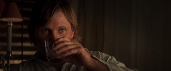 Movie still from “Hidalgo” (2004), directed by Joe Johnston – A man drinking a glass of water in a dark room; Close Up shot, Over the shoulder angle