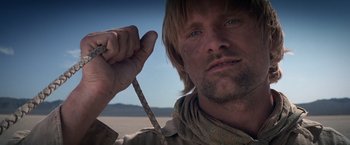 Movie still from “Hidalgo” (2004), directed by Joe Johnston – A person holding a rope; Close Up shot, Low angle
