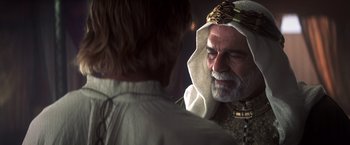 Movie still from “Hidalgo” (2004), directed by Joe Johnston – An older man with a white beard is talking to a younger man; Close Up shot, Over the shoulder angle