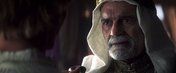 Movie still from “Hidalgo” (2004), directed by Joe Johnston – An old man with a beard and a white turban; Close Up shot, Over the shoulder angle