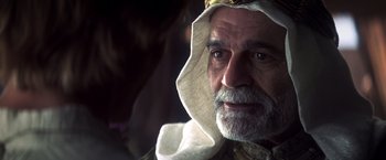 Movie still from “Hidalgo” (2004), directed by Joe Johnston – An old man with a beard and a white turban; Close Up shot, Over the shoulder angle