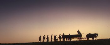 Movie still from “Hidalgo” (2004), directed by Joe Johnston – A group of people standing next to each other in a field; Extreme Wide shot, Low angle