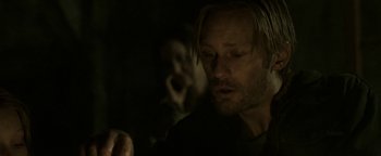 Movie still from “Hidden” (2015), directed by Ross Duffer – A person in a dark room; Close Up shot, Over the shoulder angle