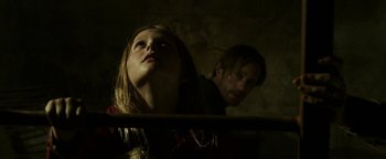 Movie still from “Hidden” (2015), directed by Ross Duffer – A man and a woman looking up at the sky; Close Up shot, Low angle