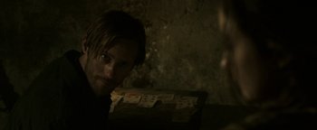 Movie still from “Hidden” (2015), directed by Ross Duffer – A man is sitting in front of a bunch of playing cards; Close Up shot, Over the shoulder angle