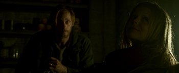 Movie still from “Hidden” (2015), directed by Ross Duffer – A man and a woman sitting in a dark room; Close Up shot, Over the shoulder angle